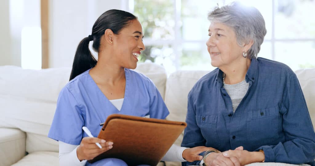 Paradigm Senior Living | Senior woman and her caregiver smiling